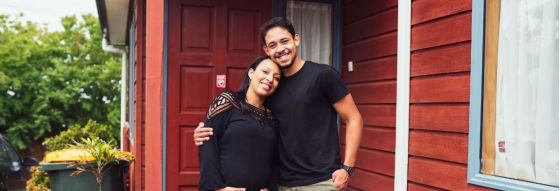 New Zealand couple are standing on the driveway outside their new home