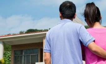 couple is looking at a house to buy at auction