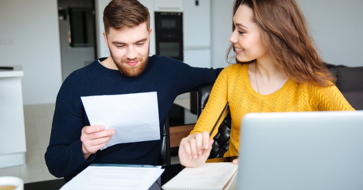 How to live off one income: Couple on laptop