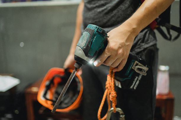 Close-up of builder holding power tool