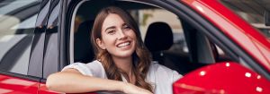 best car insurance: woman smiling in car